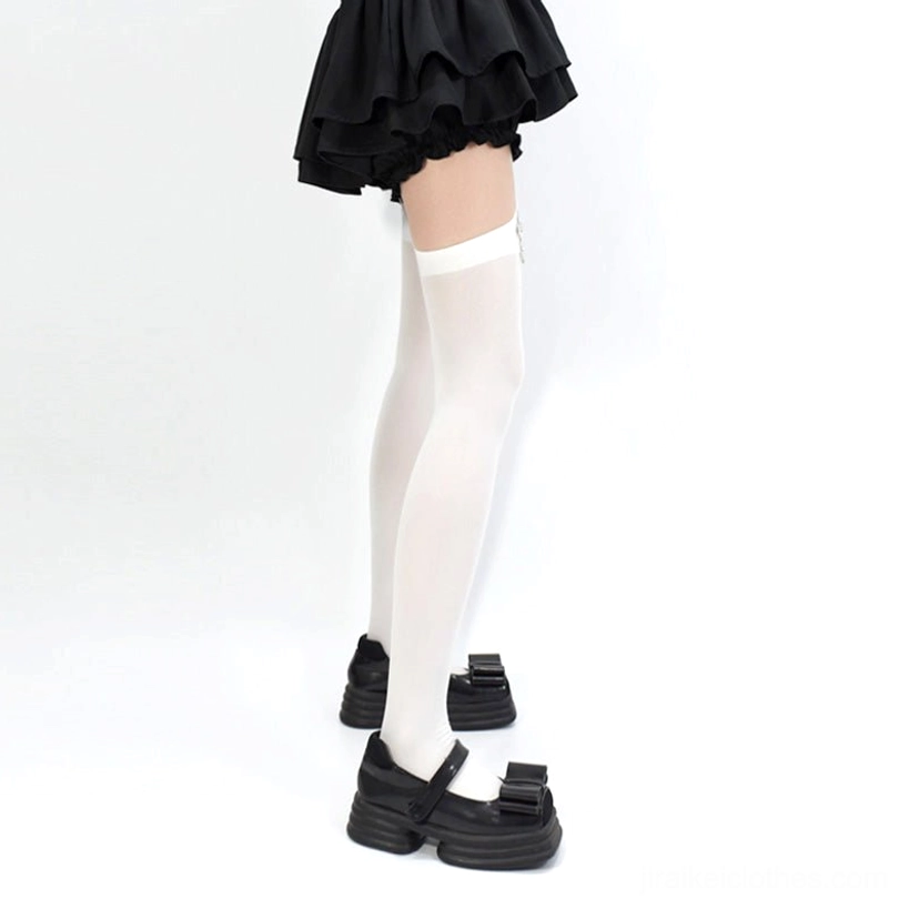 White velvet Jirai Kei garter stockings side view showing thigh-high silhouette and elastic garter strap on model wearing platform loafers