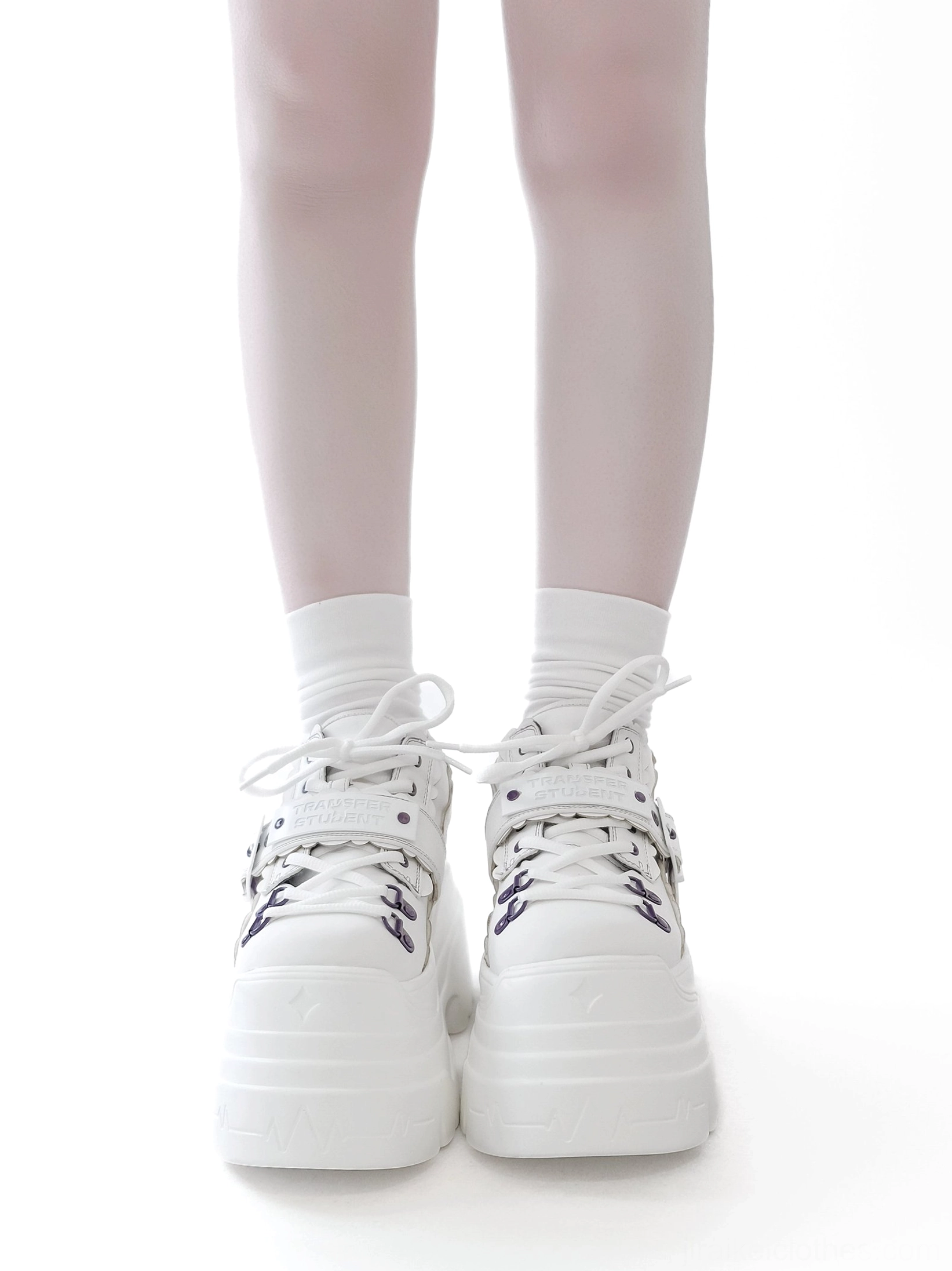 White Y2K jirai kei chunky platform shoes with purple eyelet details, front view on female model wearing white socks, plain background