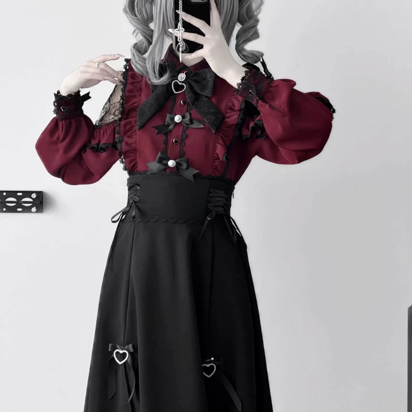 Wine red jirai kei blouse close-up front view heart-shaped bow pearl button detail grey curly hair model charm accent
