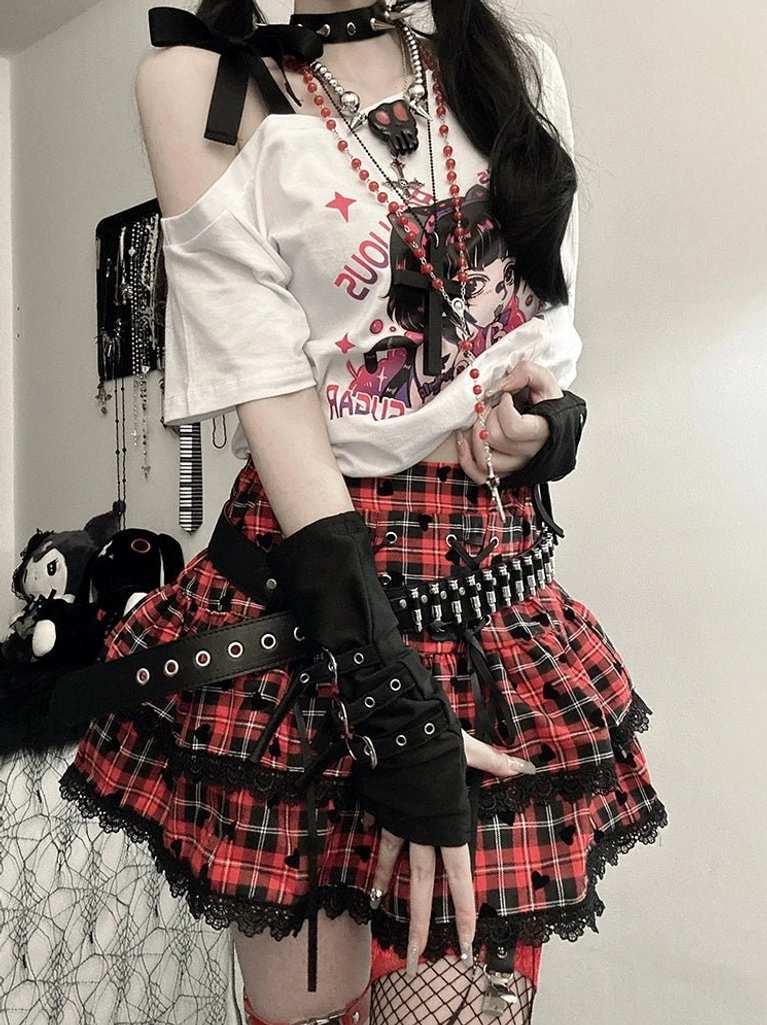 Product detail of black-white plaid mini skirt showing cake-style silhouette, above-knee length, lace trim hem, heart decorative elements, and strap details