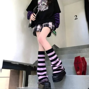 Y2K Jirai Kei black and purple horizontal striped leg warmers with slouchy fit worn on staircase by female model in casual streetwear