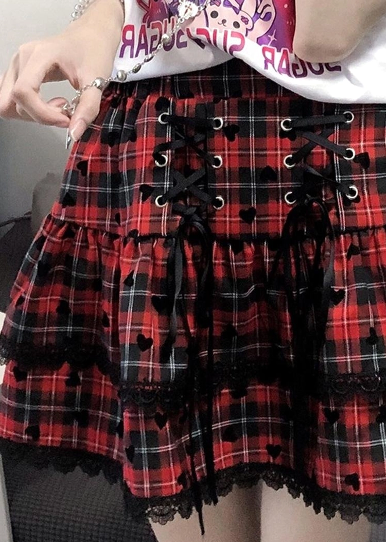 Y2K Jirai Kei skirt set showing off-shoulder short-sleeve anime graphic tee and layered plaid ruffle skirt with lace hem construction details