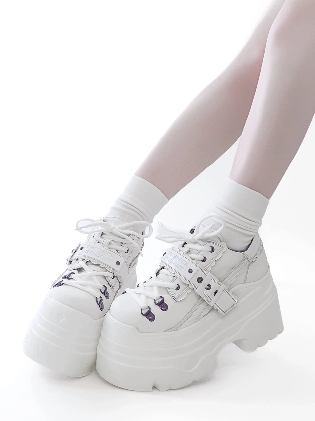 Y2K jirai kei platform shoes close-up of construction quality, stitching, purple eyelet hardware, and space leather material texture