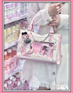 Y2K Jirai Kei square ita bag with clear anime display window, pink and white color scheme, oblique side view showcasing detachable star chain and crossbody strap