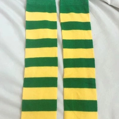 Yellow and green striped over-the-knee socks flat lay display, bright contrasting horizontal stripes, white background